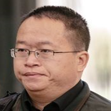 Identification photograph of Hao Zhang wearing glasses and a dark shirt