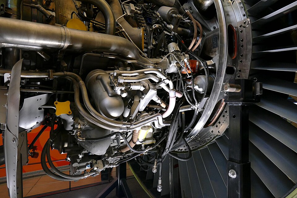 Detailed frontal view of a GE90 aircraft engine showing its large composite fan blades