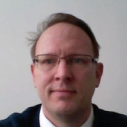 Corporate headshot of Klaus Pflugbeil wearing glasses and a dark jacket