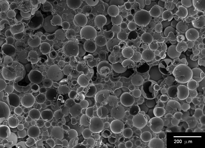 Scanning electron micrograph of hollow glass spheres embedded in syntactic foam